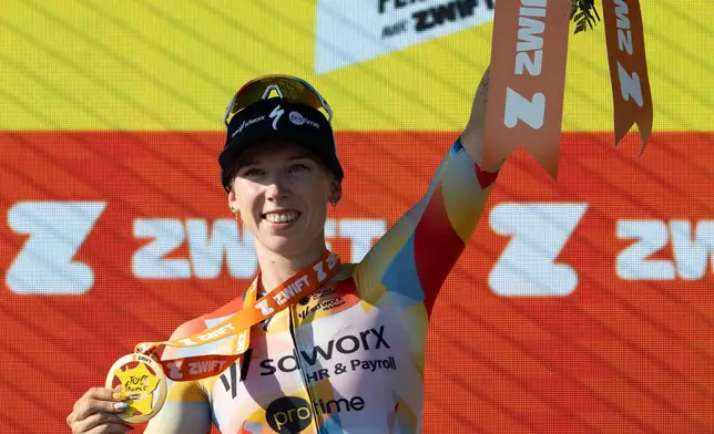 Netherlands' Lorena Wiebes of team SD Worx Protime celebrates on the podium after winning the first stage of the Women's Tour de France cycling race (Tour de France Femmes), in Lausanne, Switzerland, Saturday, Aug. 1, 2026. (Jean-Christophe Bott/Keystone via AP)