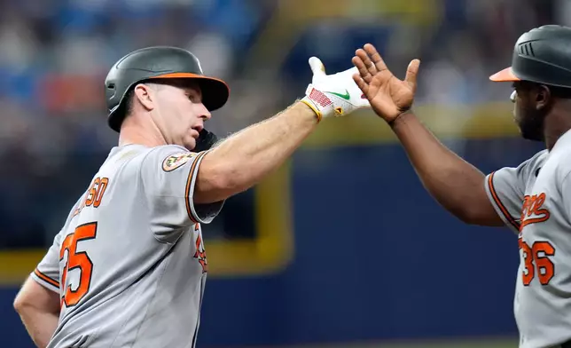 Baltimore Orioles' Pete Alonso (25) celebrates with first base coach Jason Bourgeois sfter his home run off Tampa Bay Rays pitcher Ian Seymour during the fifth inning of a baseball game Saturday, Aug. 15, 2026, in St. Petersburg, Fla. (AP Photo/Chris O'Meara)