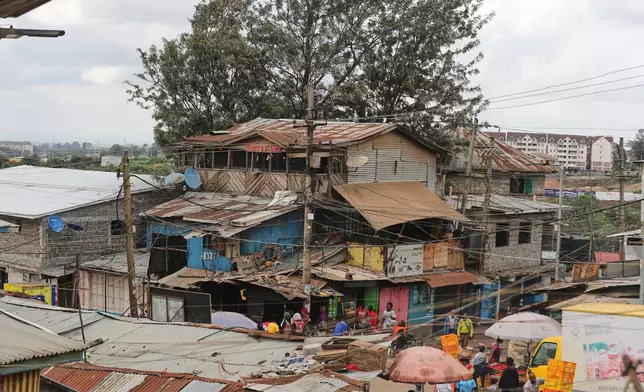 FILE -A view of electric wire poles and cables towering over the Kibera informal settlement in Nairobi, Kenya, March 31, 2026. (AP Photo/Henry Naminde, File)