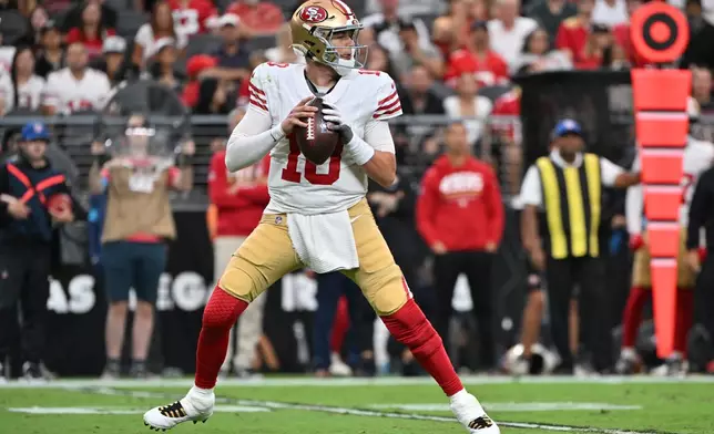 San Francisco 49ers quarterback Mac Jones looks for a receiver during the first half of an NFL preseason football game against the Las Vegas Raiders, Thursday, Aug. 27, 2026}, in Las Vegas. (AP Photo/David Becker)