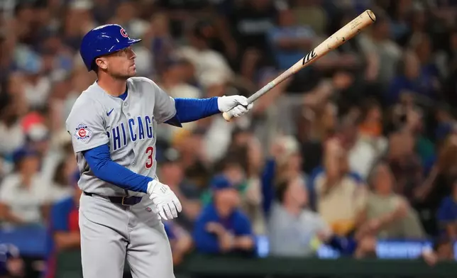 Chicago Cubs' Alex Bregman follows through on a solo home run against the Seattle Mariners during the ninth inning of a baseball game, Friday, Aug. 21, 2026, in Seattle. (AP Photo/Lindsey Wasson)