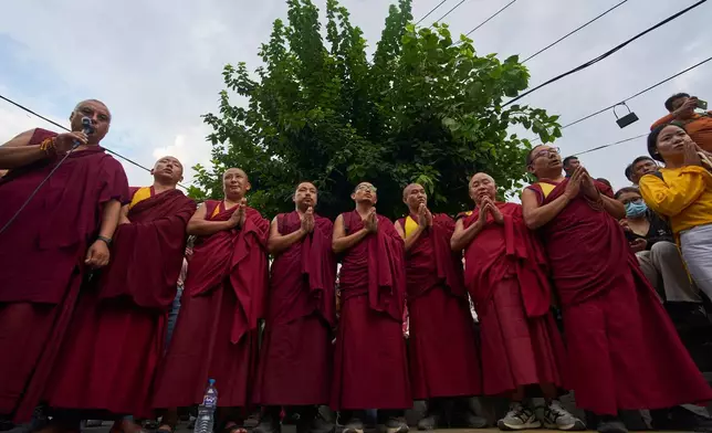 Monks chant religious mantras before lighting candles in memory of the climbers who died Thursday in an avalanche on Pakistan's Broad Peak, Kathmandu, Nepal, Tuesday, Aug. 4, 2026. (AP Photo/Niranjan Shrestha)