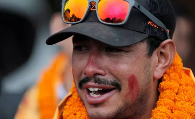 FILE - Nepalese mountaineer Nirmal Purja, who became the fastest climber of the world's 14 highest peaks, arrives at the airport in Kathmandu, Nepal, on Oct. 30, 2019. (AP Photo/Niranjan Shrestha, File)