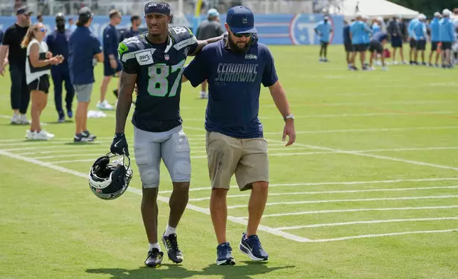 Seattle Seahawks wide receiver Montorie Foster Jr. (87) is helped off the field after a joint NFL football practice against the Tennessee Titans, Friday, Aug. 21, 2026, in Nashville, Tenn. (AP Photo/George Walker IV)
