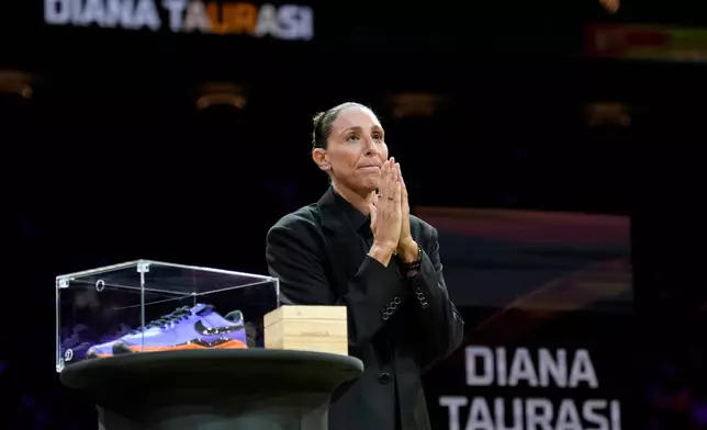 Retired WNBA Phoenix Mercury basketball player Diana Taurasi acknowledges the cheering crowd as she is honored during a halftime Ring of Honor ceremony Sunday, Aug. 16, 2026, in Phoenix. (AP Photo/Ross D. Franklin)