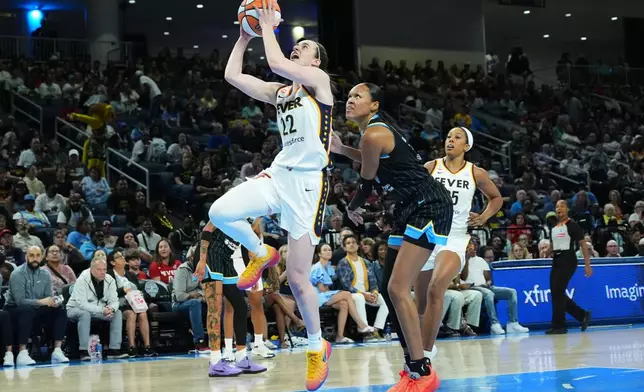Indiana Fever guard Caitlin Clark, center left, drives to the basket past Chicago Sky forward/center Azura Stevens, center right, during the first half of a WNBA basketball game Sunday, Aug. 23, 2026, in Chicago. (AP Photo/Nam Y. Huh)