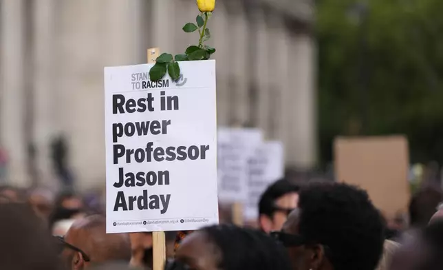 A sign is held during a vigil by Stand Up to Racism in memory of late University of Cambridge professor Jason Arday at Trafalgar Square in London, Monday, Aug. 17, 2026. (AP Photo/Kirsty Wigglesworth)