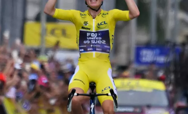 Netherlands' Demi Vollering celebrates as she crosses the finish line to win the ninth stage of the Women's Tour de France cycling race (Tour de France Femmes) in Nice, France, Sunday, Aug. 9, 2026. (AP Photo/Philippe Magoni)