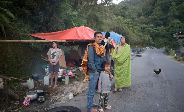 People take shelter in makeshift tent amid fears of aftershocks, following an earthquake in Reo, East Nusa Tenggara province, Indonesia, Monday, Aug. 17, 2026. (AP Photo/Firdia Lisnawati)