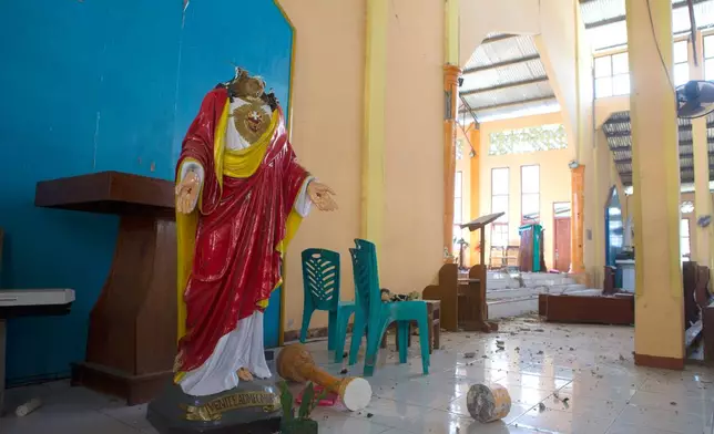 A broken statue of Jesus Christ is seen inside an earthquake-damaged church in Reo, East Nusa Tenggara province, Indonesia, Monday, Aug. 17, 2026. (AP Photo/Firdia Lisnawati)