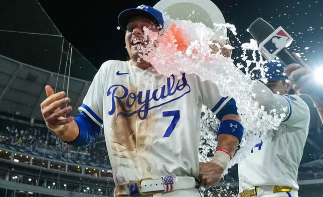 Kansas City Royals' Bobby Witt Jr. (7) is doused by Jac Caglianone after their baseball game against the Minnesota Twins, Tuesday, Aug. 4, {t yr4}, in Kansas City, Mo. (AP Photo/Charlie Riedel)