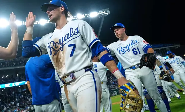 Kansas City Royals' Bobby Witt Jr. (7) celebrates with teamates after their baseball game against the Minnesota Twins, Tuesday, Aug. 4, {t yr4}, in Kansas City, Mo. (AP Photo/Charlie Riedel)