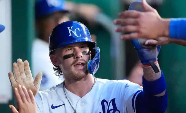 Kansas City Royals' Bobby Witt Jr. celebrates in the dugout after scoring on a fielder's choice hit into by Jac Caglianone during the fifth inning of a baseball game against the Minnesota Twins, Tuesday, Aug. 4, 2026, in Kansas City, Mo. (AP Photo/Charlie Riedel)
