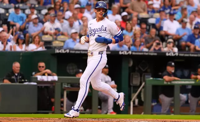 Kansas City Royals' Bobby Witt Jr. scores on a sacrifice fly hit by Salvador Perez during the first inning of a baseball game against the Minnesota Twins, Tuesday, Aug. 4, 2026, in Kansas City, Mo. (AP Photo/Charlie Riedel)