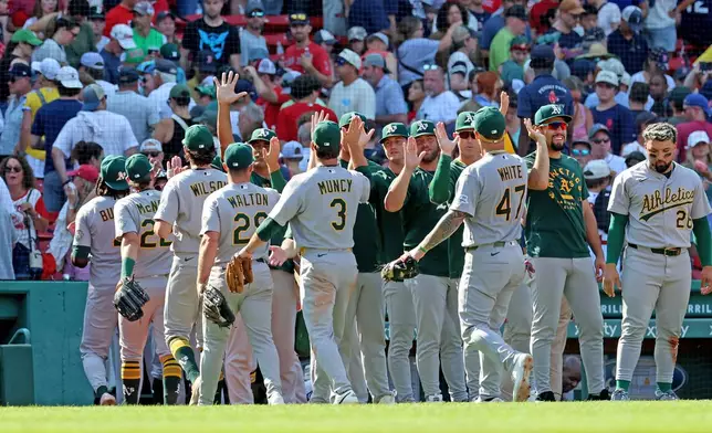 The Athletics celebrate their win over the Boston Red Sox at the end of a baseball game against the Boston Red Sox, Sunday, Aug. 9, 2026, in Boston. (AP Photo/Mark Stockwell)