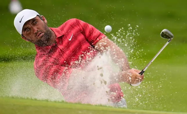 Scottie Scheffler hits from a bunker to the first green during the third round of the PGA Tour Championship golf tournament, Saturday, Aug 29, 2026, in Atlanta.(AP Photo/Mike Stewart)