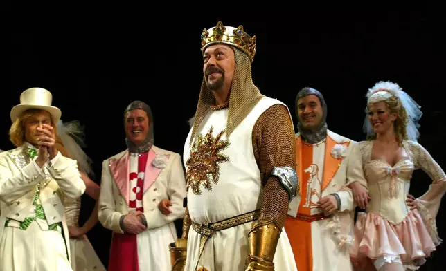 FILE - Tim Curry performs a number from the musical "Spamalot" during the Broadway premiere on March 17, 2005, in New York, (AP Photo/Stuart Ramson, File)