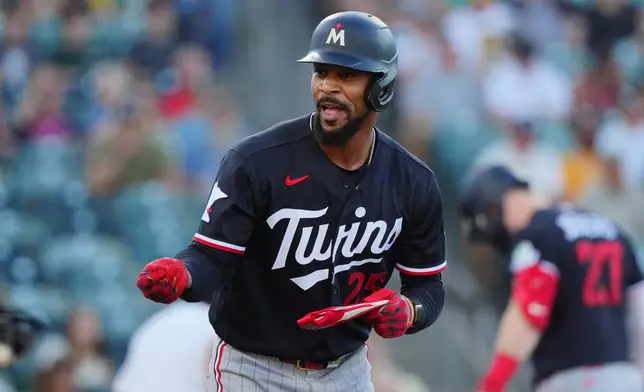 Minnesota Twins' Byron Buxton reacts while running to first base after winning a challenge in the first inning during a baseball game against the Athletics, Monday, Aug. 24, 2026, in West Sacramento, Calif. (AP Photo/Alan Greth)