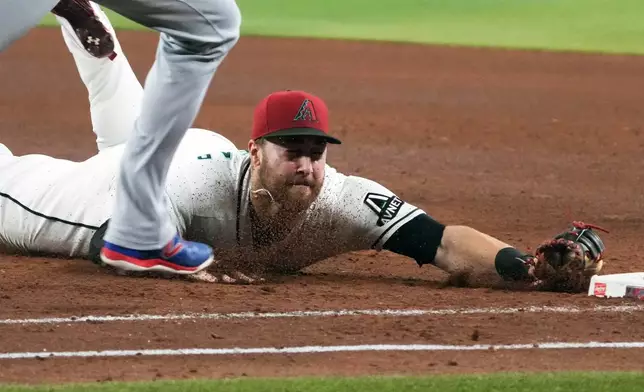 Arizona Diamondbacks first baseman Tyler Locklear gets a force out against Los Angeles Dodgers' Shohei Ohtani in the fifth inning of a baseball game, Sunday, Aug 9, 2026, in Phoenix. (AP Photo/Rick Scuteri)