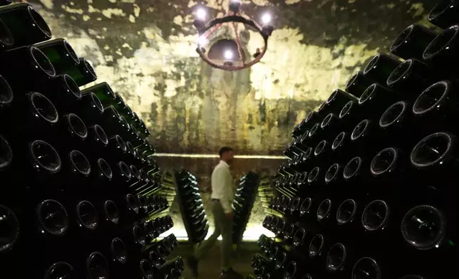 A man walks in a Berlucchi's hold cantina in Corte Franca, northern Italy, Thursday, Aug. 6, 2026. (AP Photo/Antonio Calanni)