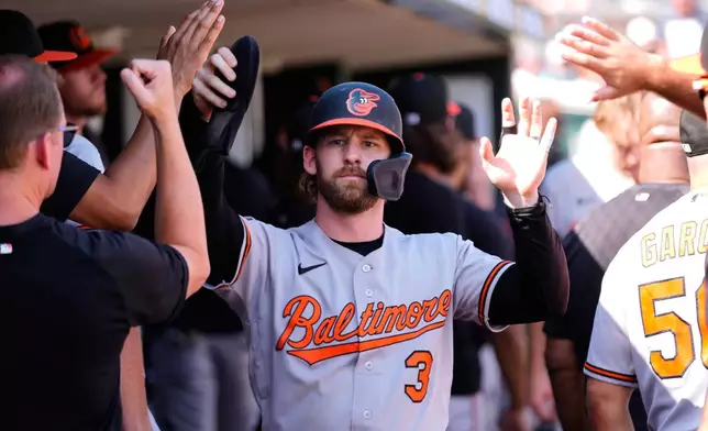 Baltimore Orioles' Taylor Ward (3) celebrates scoring against the Detroit Tigers during the 12th inning of a baseball game Wednesday, July 29, 2026, in Detroit. (AP Photo/Paul Sancya)