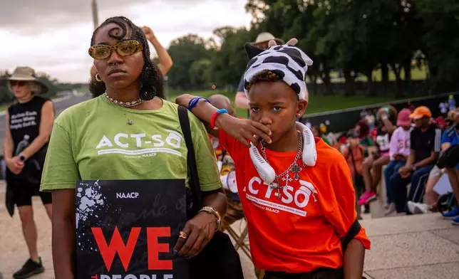 Demonstrators listen to speakers during the March on Washington, Friday, Aug. 28, 2026, near the Lincoln Memorial in Washington. (AP Photo/Julia Demaree Nikhinson)