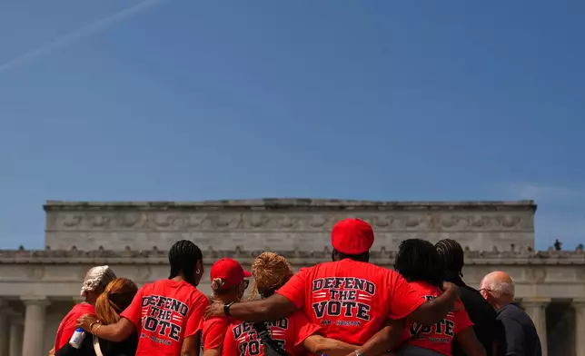 Demonstrators pose for a photo near the Lincoln Memorial during the March on Washington, Friday, Aug. 28, 2026, in Washington. (AP Photo/Julia Demaree Nikhinson)