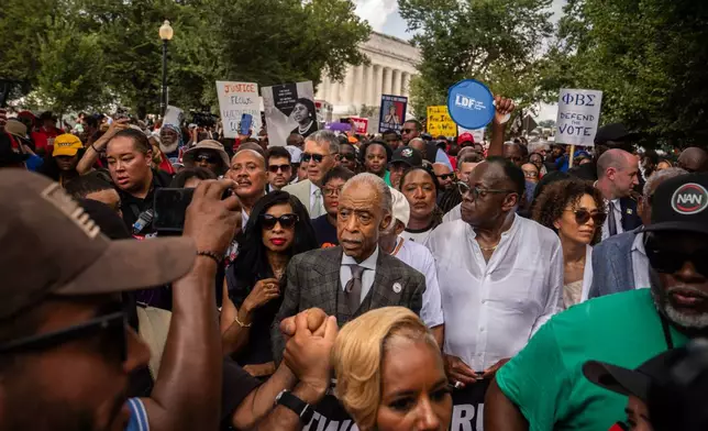 Rev. Al Sharpton, center, and other activists walk from the Lincoln Memorial to the Martin Luther King, Jr. Memorial during the March on Washington, Friday, Aug. 28, 2026, in Washington. (AP Photo/Julia Demaree Nikhinson)