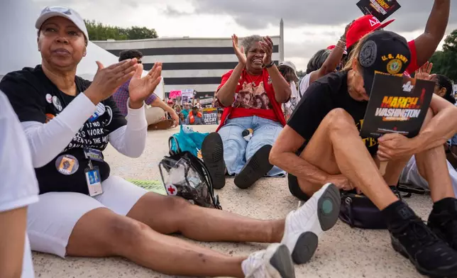 Demonstrators listen to speakers during the March on Washington, Friday, Aug. 28, 2026, near the Lincoln Memorial in Washington. (AP Photo/Julia Demaree Nikhinson)