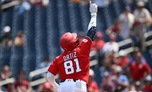 Washington Nationals' Abimelec Ortiz celebrates his solo home run during the third inning of a baseball game against the Cincinnati Reds, Sunday, Aug. 9, 2026, in Washington. (AP Photo/Nick Wass)