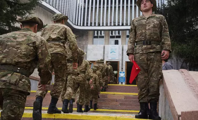 A Kazakhstan's soldiers line-up to vote at a polling station during early parliamentary elections in Almaty, Kazakhstan, Sunday, Aug. 23, 2026. (AP Photo/Vladimir Tretyakov)