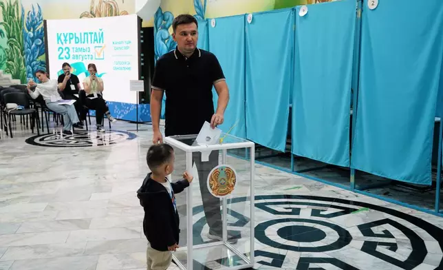 A man casts his ballot at a polling station during early parliamentary elections in Almaty, Kazakhstan, Sunday, Aug. 23, 2026. (AP Photo/Vladimir Tretyakov)