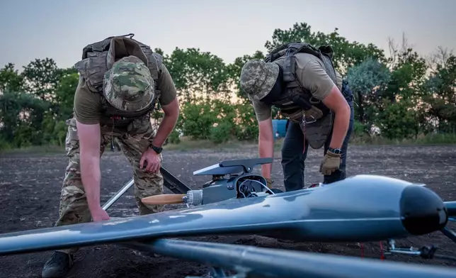 Ukrainian servicemen prepare a "Chaklun" strike drone used for deep-strike operations against Russian positions in Crimea, in an undisclosed location in Ukraine on Thursday, Aug. 6, 2026. (AP Photo/Dan Bashakov)