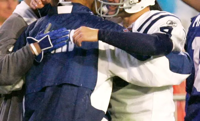 FILE - Indianapolis Colts kicker Adam Vinatieri (4) hugs coach Tony Dungy late in the fourth quarter of the Super Bowl XLI football game against the Chicago Bears at Dolphin Stadium in Miami, Feb. 4, 2007. (AP Photo/Chris O'Meara, File)
