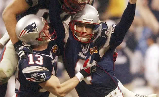 FILE - New England Patriots kicker Adam Vinatieri celebrates his game-winning field goal with teammates Ken Walter (13) and Christian Fauria (88) in the final seconds of Super Bowl XXXVIII against the Carolina Panthers at Reliant Stadium in Houston, Feb. 1, 2004. (AP Photo/Dave Martin, File)
