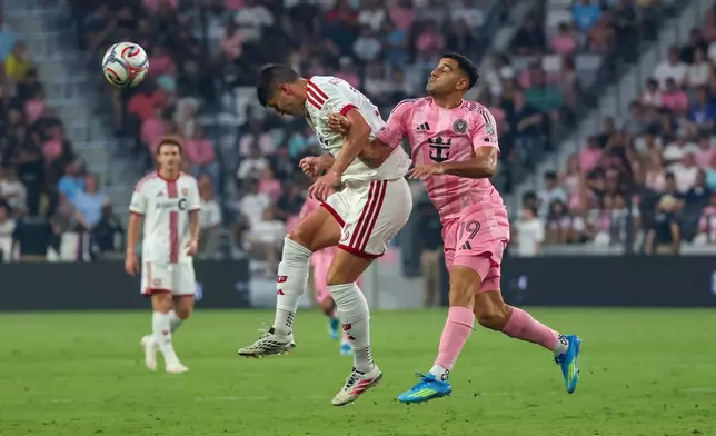 Toronto FC defender Benjamín Kuscevic (13) jumps for the ball against Inter Miami forward Germán Berterame (19) during the first half of an MLS soccer game on Saturday, Aug. 22, 2026, in Miami. (AP Photo/David Santiago)