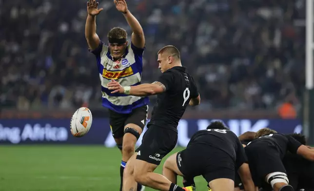 All Blacks' Cortez Ratima, center, kicks the ball during a friendly rugby match between Stormers and All Blacks, in Cape Town, South Africa, Friday, Aug. 7, 2026. (AP Photo/Halden Krog)
