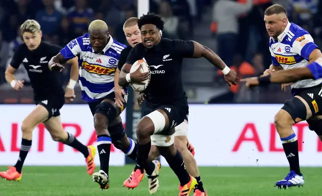 All Blacks' Peter Lakai, center, breaks away from Stromers' players during a friendly rugby match between Stormers and All Blacks, in Cape Town, South Africa, Friday, Aug. 7, 2026. (AP Photo/Halden Krog)
