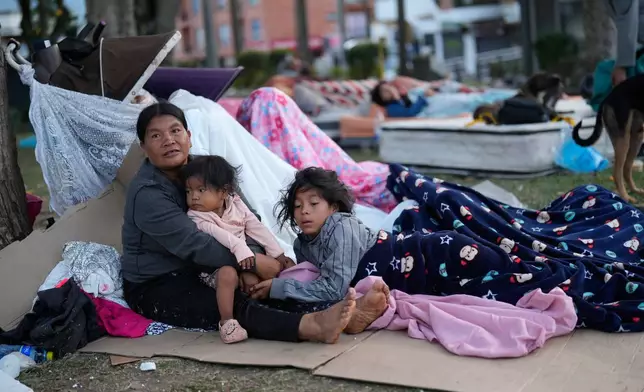 People camp out in a park two days after an earthquake damaged their homes in Pereira, Colombia, Wednesday, Aug. 12, 2026. (AP Photo/Fernando Vergara)