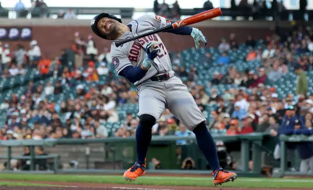 Houston Astros' Jose Altuve (27) reacts after being hit by a pitch during the first inning of a baseball game against the San Francisco Giants in San Francisco, Tuesday, Aug. 11, 2026. (AP Photo/Jed Jacobsohn)