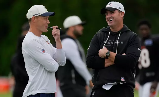 Chicago Bears head coach Ben Johnson, left, and Cincinnati Bengals head coach Zac Taylor, right, talk during a joint NFL football practice Thursday, Aug. 20, 2026, in Cincinnati. (AP Photo/Carolyn Kaster)