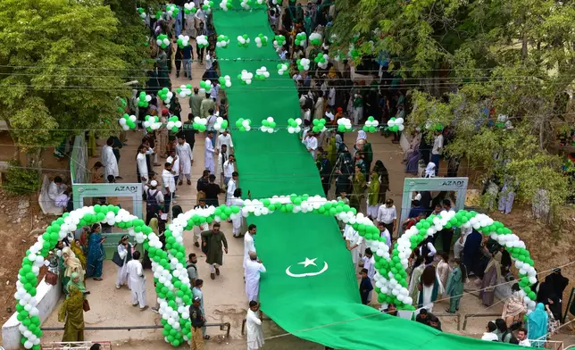 University students attend a ceremony in connection with the Pakistan's Independence Day celebrations, in Karachi, Pakistan, Thursday, Aug. 13, 2026. (AP Photo/Ali Raza)