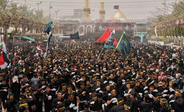Shiite Muslim worshippers march toward the Imam Hussein Shrine ahead of Arbaeen, the annual Shiite commemoration marking 40 days after Ashoura, in Karbala, Iraq, Monday, Aug. 3, 2026. (AP Photo/Hadi Mizban)