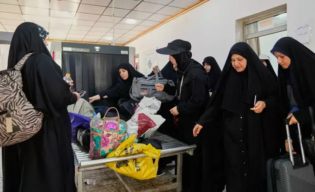 Iranian Shite pilgrims arrive at the Al-Mundheriya border crossing to join millions of Muslims heading to the holy city of Karbala for the annual Arbaeen pilgrimage, in Diyala, Iraq, Monday, July 27, 2026. (AP Photo/Hadi Mizban)