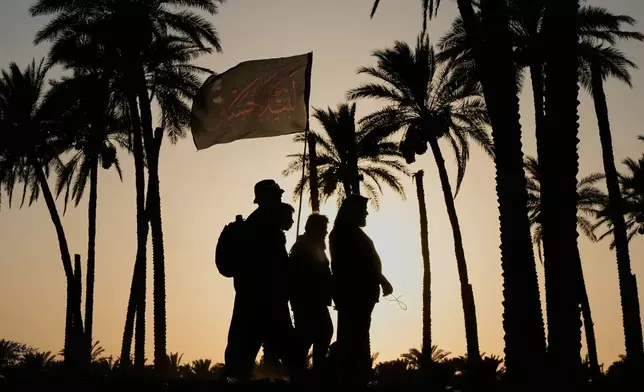 Shiite pilgrims march to Karbala for Arbaeen, the annual Shiite commemoration marking 40 days after Ashura, in Babil, Iraq, Saturday, Aug. 1, 2026. (AP Photo/Hadi Mizban)