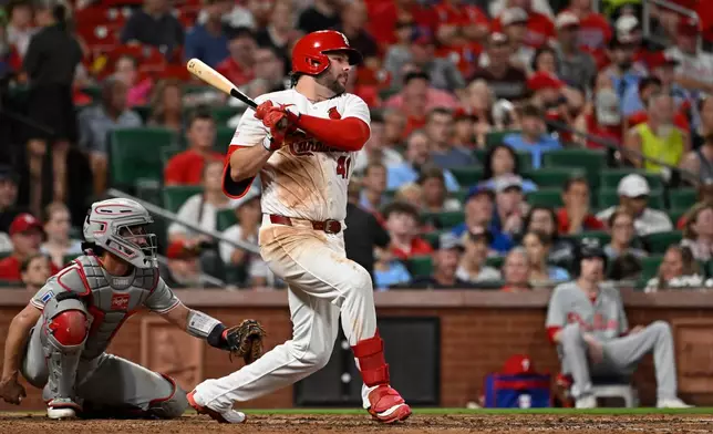St. Louis Cardinals' Alec Burleson, front right, watches his two-run single in front Philadelphia Phillies catcher Garrett Stubbs, left, in the sixth inning of a baseball game, Monday, Aug. 10, 2026, in St. Louis. (AP Photo/Joe Puetz)