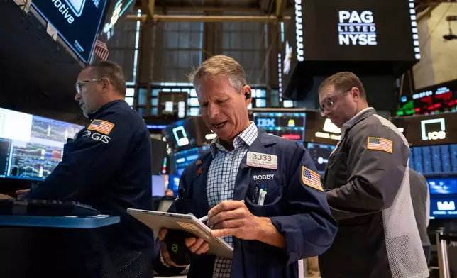 Trader Robert Charmak works on the floor of the New York Stock Exchange in New York, Friday, Aug. 21, 2026. (AP Photo/Yuki Iwamura)