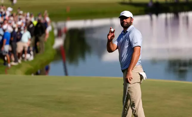 Scottie Scheffler celebrates winning on the 18th green the final round of the St. Jude Championship golf tournament, Sunday, Aug. 16, 2026, in Memphis, Tenn. (AP Photo/George Walker IV)