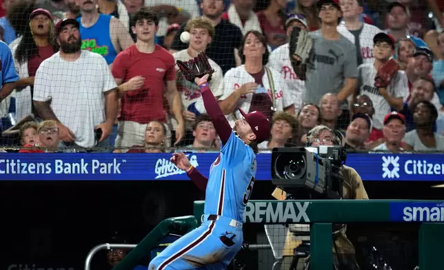 Philadelphia Phillies third baseman Bryson Stott catches a pop foul out by Washington Nationals' CJ Abrams during the seventh inning of a baseball game Thursday, Aug. 6, 2026, in Philadelphia. (AP Photo/Matt Slocum)