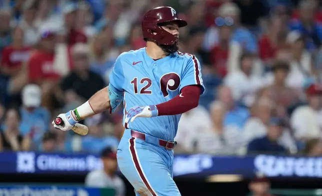 Philadelphia Phillies' Kyle Schwarber follows through after hitting a run-scoring single against Washington Nationals pitcher Max Kranick during the sixth inning of a baseball game Thursday, Aug. 6, 2026, in Philadelphia. (AP Photo/Matt Slocum)